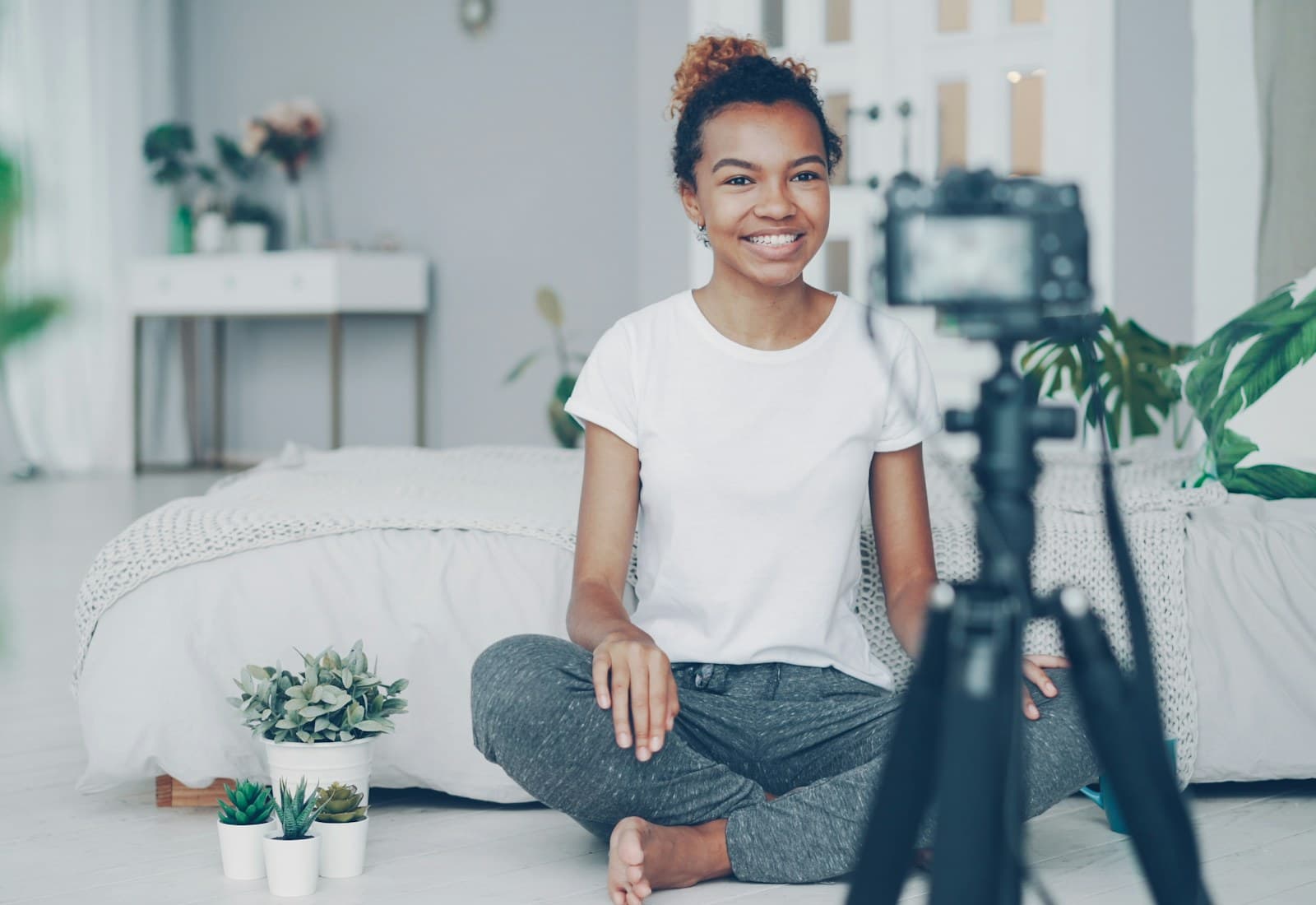 A creator filming content at home in warm natural light